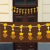 Nestaariya Swastik Door Toran with yellow flowers, Swastik symbols, and pearl accents – festive door bandanwar for main doors and pooja rooms