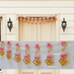 Nestaariya Pink Flower Swastik Toran with pearl beads – handcrafted auspicious floral door hanging for main doors and pooja room décor